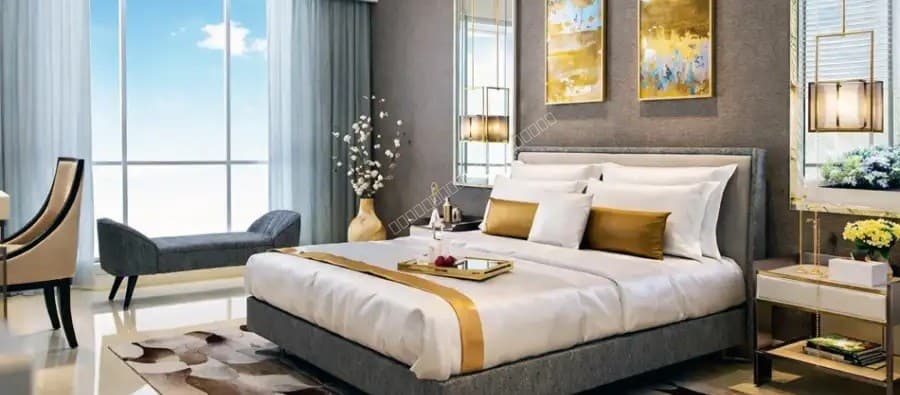 Spacious master bedroom with plush bedding and city window view
