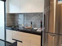 Modern kitchen setup with stainless steel refrigerator and cabinets