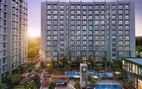 Modern residential towers overlooking landscaped podium and sports court