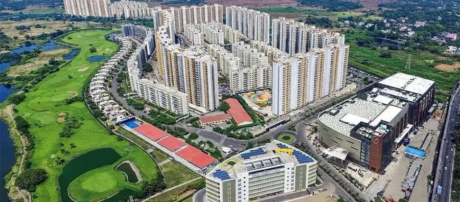 Aerial bird-eye view of residential township towers and sports grounds